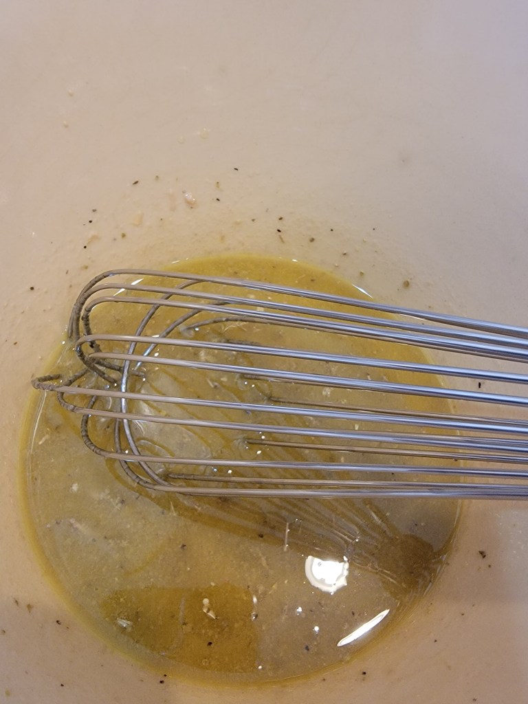 whisking a salad dressing in bowl