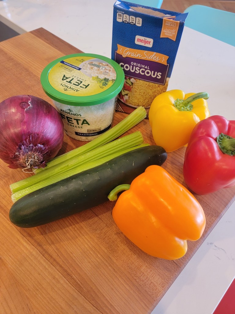 wooden board with fresh whole veggies