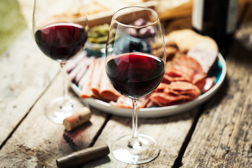Two glasses of red wine with food