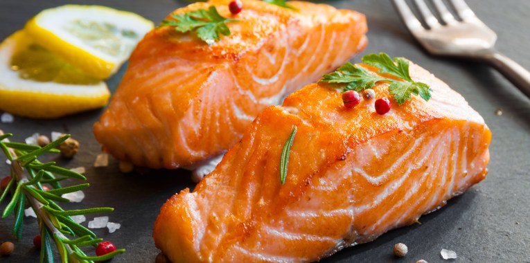 pieces of salmon on black slate