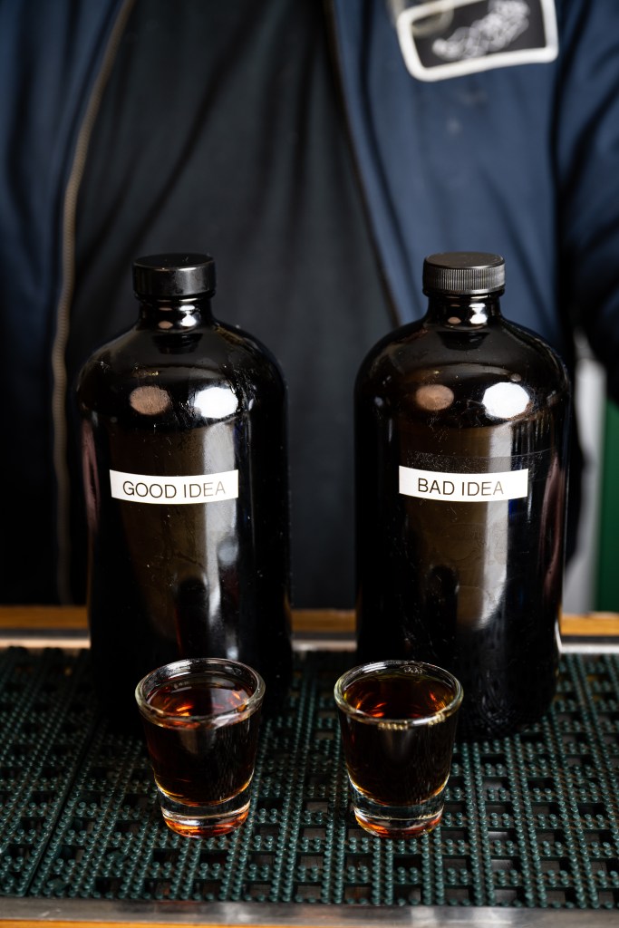 two bottles with shotglasses filled