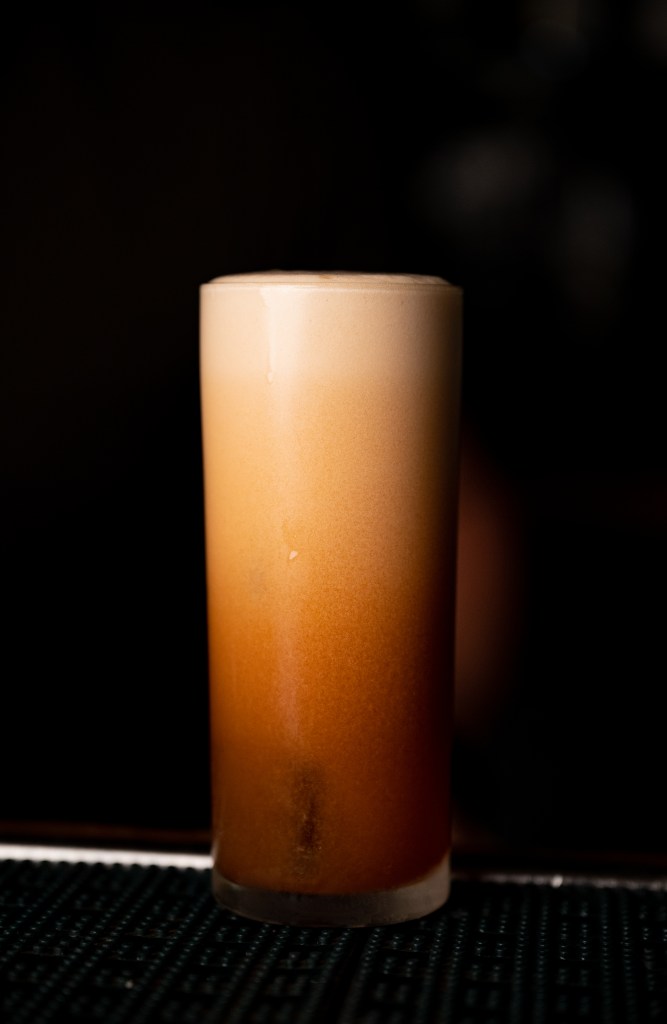 milk punch cocktail dark background
