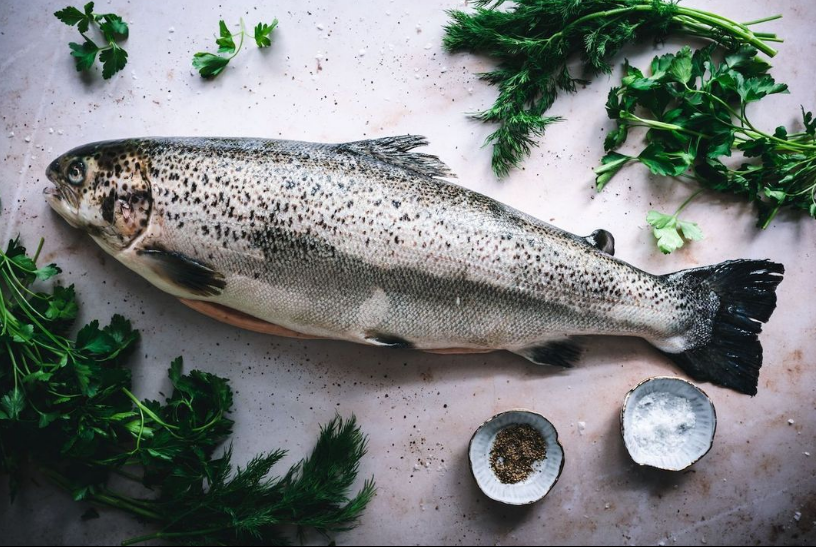 whole salmon on white counter