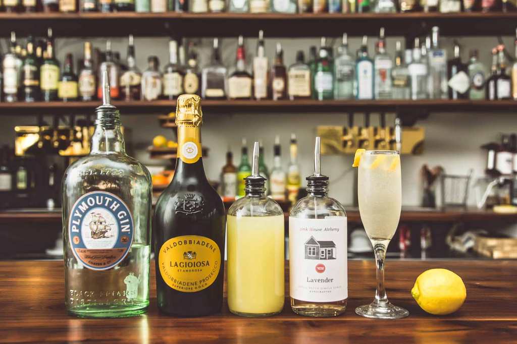 bar with several bottles and a champagne glass