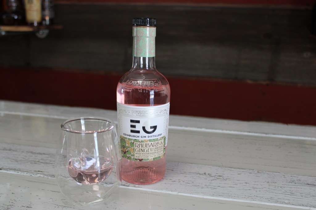 pink liquor in bottle on white bar