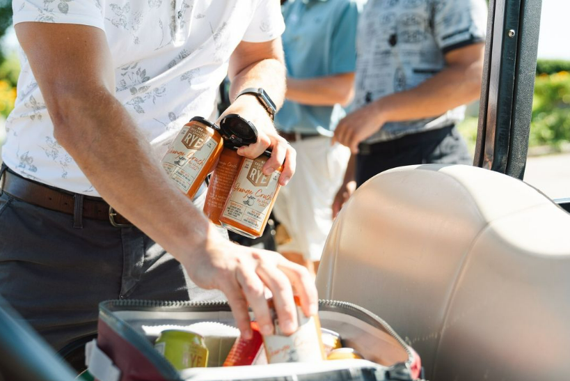 man packing cans of Sagamore Spirit
